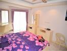 Bright and cozy bedroom with purple floral bedding and ample storage