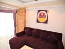 Well-furnished living room with dark purple sofa and wall art