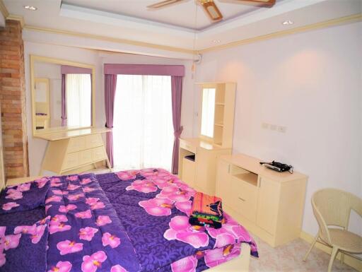 Comfortable bedroom with colorful bedding and ample storage