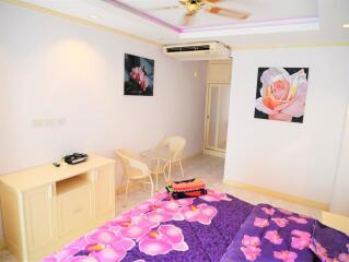 Bright bedroom with floral decor and modern amenities