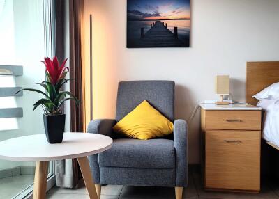 Cozy bedroom corner with armchair and bedside table