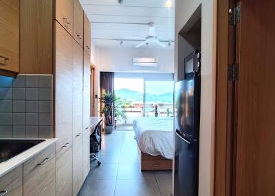 Bedroom with a view, adjoining kitchenette, and workspace