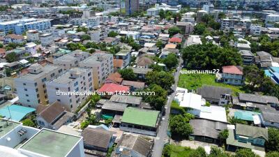 Aerial view of a neighborhood with various buildings and a labelled street.