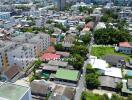 Aerial view of a neighborhood with various buildings and a labelled street.