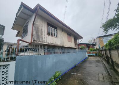 Exterior view of a building with a surrounding fence.