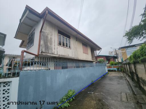 Exterior view of a building with a surrounding fence.