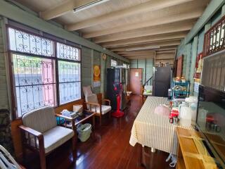 Spacious living area with wooden flooring and large windows