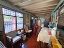 Spacious living area with wooden flooring and large windows