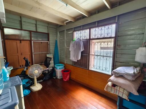 Multi-purpose utility room with wooden floor and storage