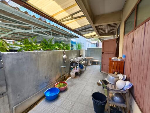 Outdoor kitchen area with assorted cookware and utensils