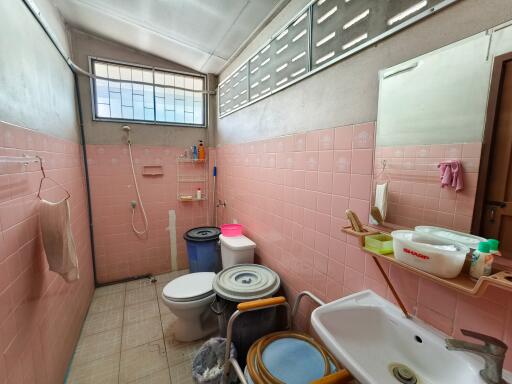 Bathroom with pink tiles and basic amenities