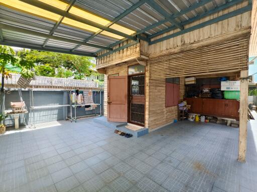 Covered outdoor area with utility space and storage