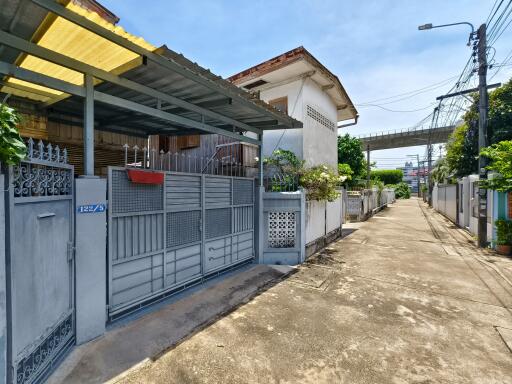 Exterior view of the property including the gated entrance and street