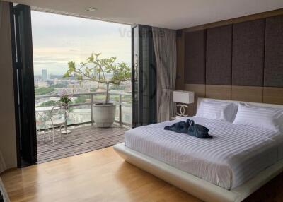 Modern bedroom with a view of the city and balcony