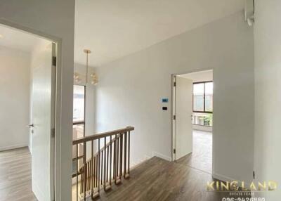 Spacious hallway with staircase and natural lighting