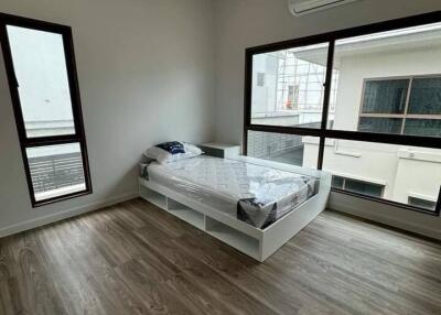 Bedroom with single bed and hardwood flooring