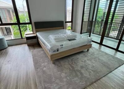 Spacious bedroom with large windows and balcony access