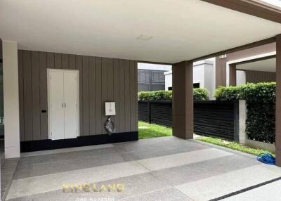 Covered carport area with adjacent grassy section