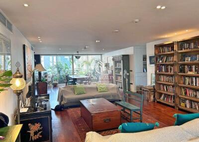 Spacious, well-lit living room with bookshelves and modern decor