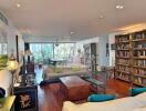 Spacious, well-lit living room with bookshelves and modern decor