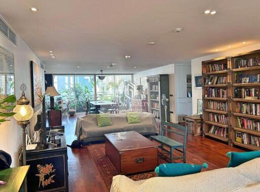 Spacious, well-lit living room with bookshelves and modern decor