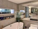 Modern bathroom with a large mirror, bathtub, and decorated shelves