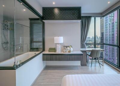 Modern bedroom with large windows and city view