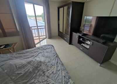 Bedroom with TV and balcony