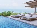 Outdoor area with pool and lounge chairs overlooking scenic view