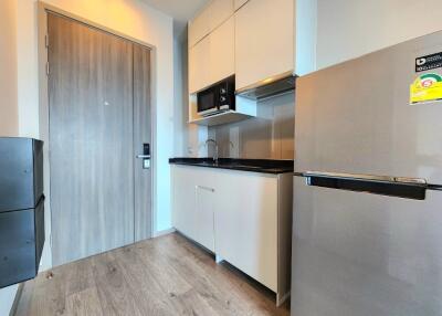 Modern compact kitchen with wood flooring