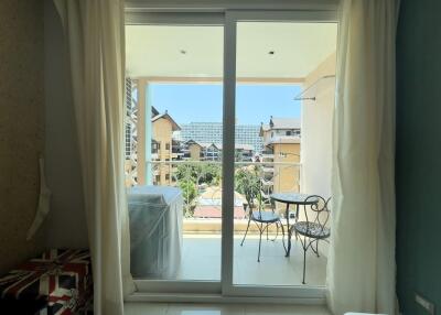 Balcony with a view of neighboring buildings and distant landscape