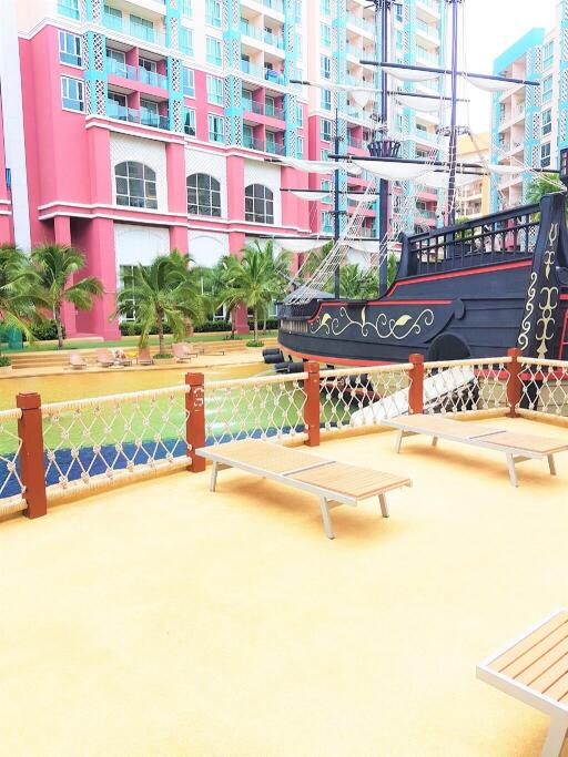 Outdoor recreational area with ship structure and lounge chairs