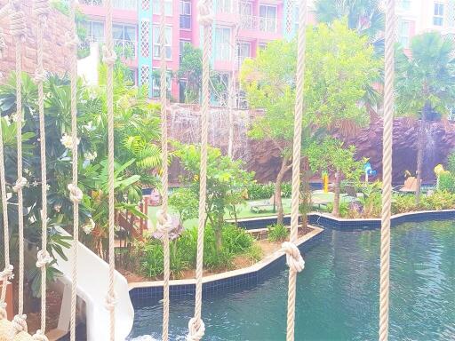 View of outdoor swimming pool with surrounding greenery