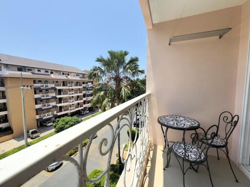 Balcony with outdoor seating and view of nearby buildings