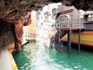 Pool area with waterfall feature inside cave-like setting