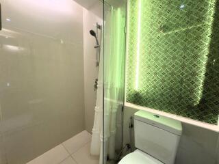 Modern bathroom with shower area and neon-lit backsplash