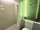 Modern bathroom with shower area and neon-lit backsplash