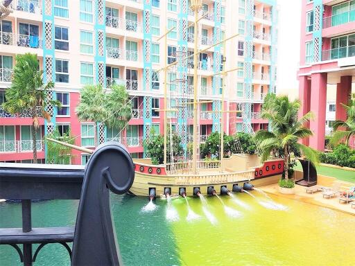 Colorful waterfront apartment building with unique pirate ship pool