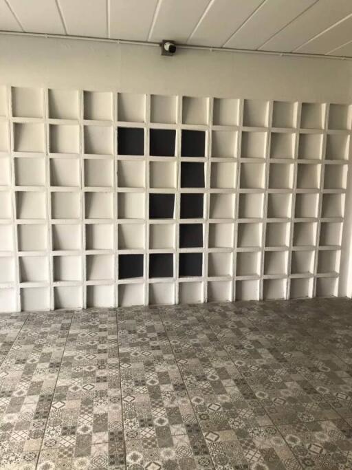 Wall with multiple storage cubbies and tiled floor