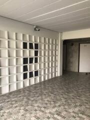 Large, open space with tiled flooring and wall shelves