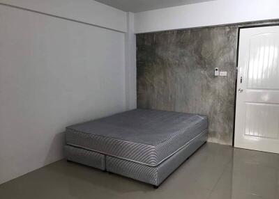 Minimalist bedroom with bed and door