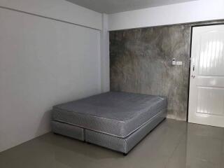 Minimalist bedroom with bed and door