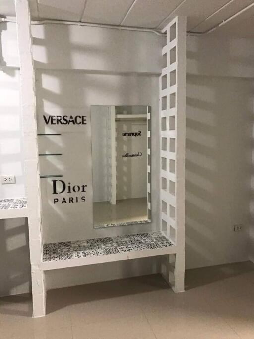 Fashion display area with mirrors and shelves