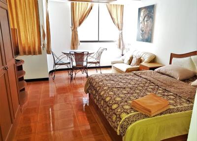 Bedroom with wooden furniture and a sitting area