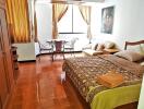 Bedroom with wooden furniture and a sitting area