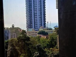 View of high-rise building with a glimpse of the sea from a window