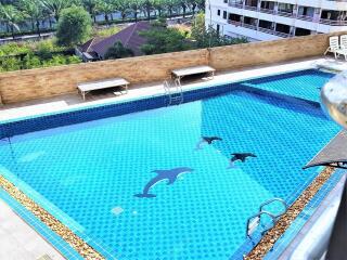 Outdoor swimming pool on rooftop with dolphin designs