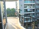 Balcony with decorative railing and view of adjacent buildings