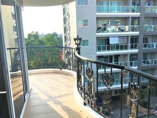 Balcony with decorative railing and view of adjacent buildings