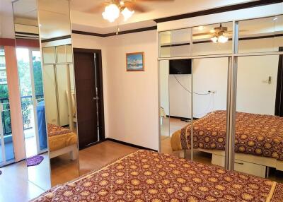 Bedroom with mirrored closet and balcony view